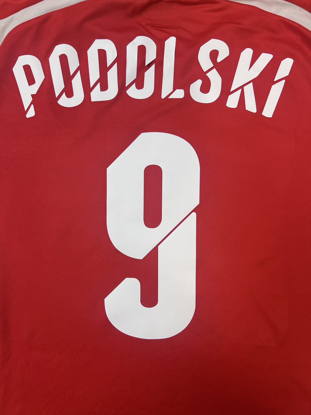 PODOLSKI 9 name and number close-up