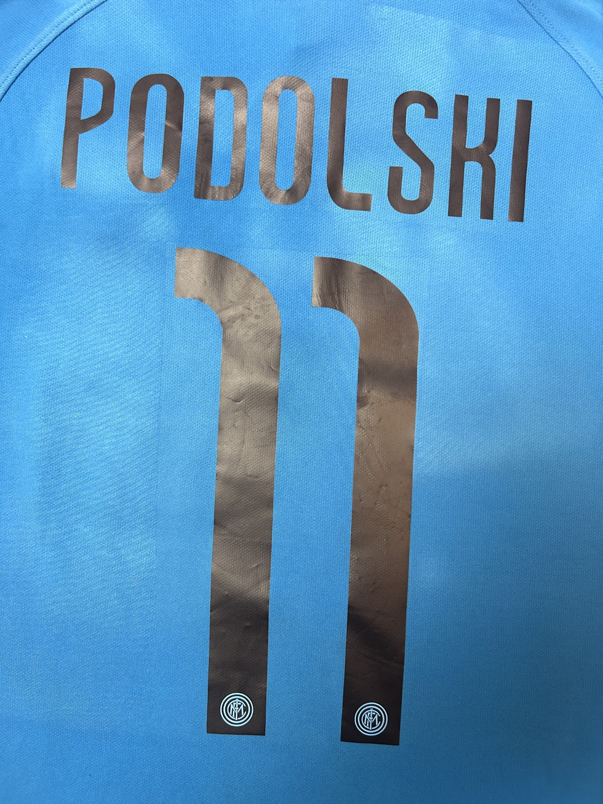 PODOLSKI 11 name and number close-up