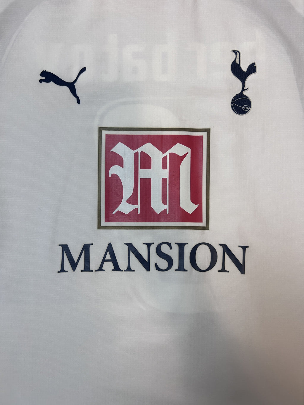 Puma logo, Spurs crest and Mansion sponsor