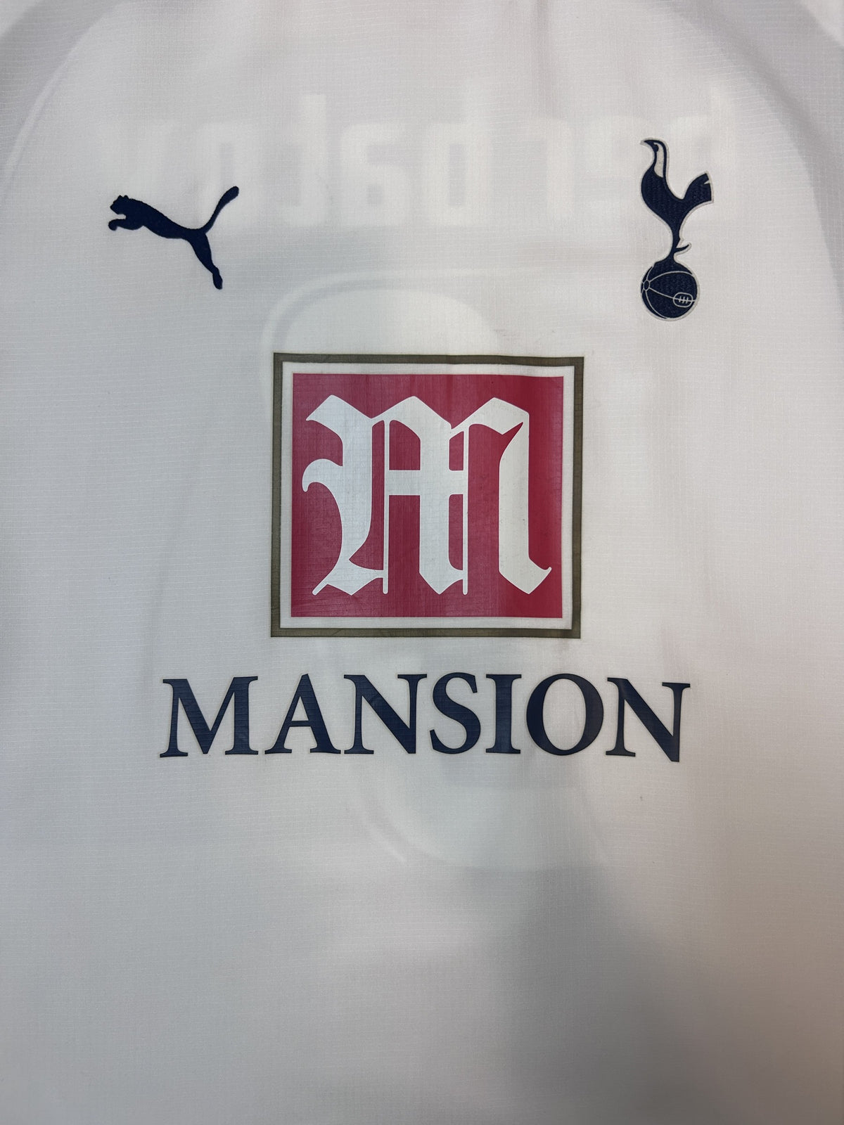Puma logo, Spurs crest and Mansion sponsor