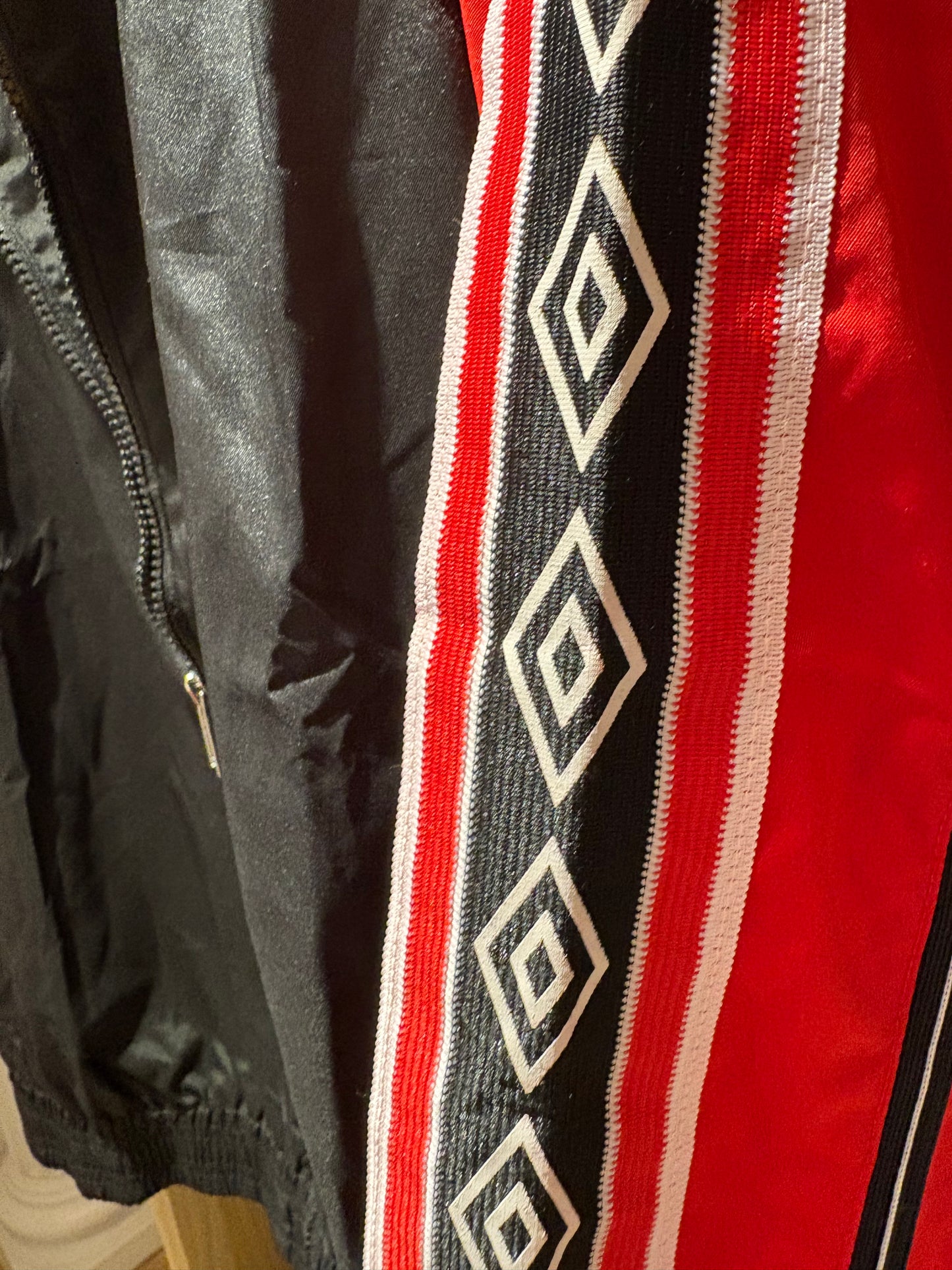 Vintage Manchester United 1998-99 Treble Winning track jacket in black and red.