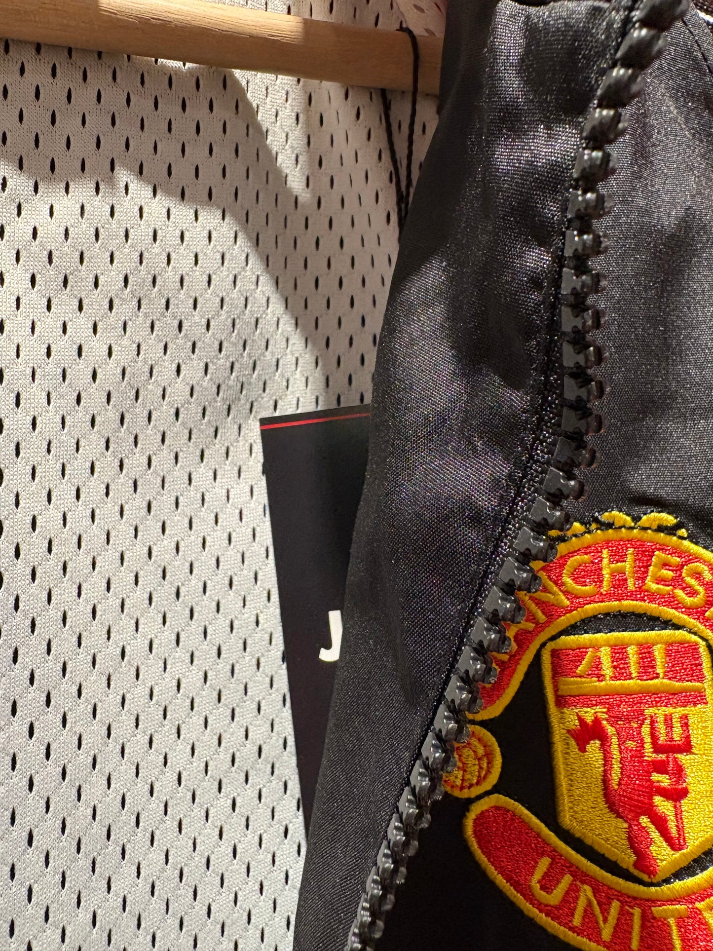 Vintage Manchester United 1998-99 Treble Winning track jacket in black and red.