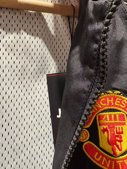 Vintage Manchester United 1998-99 Treble Winning track jacket in black and red.